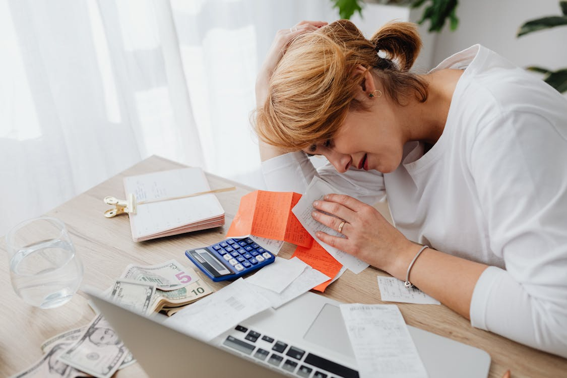 how decision fatigue affects spending illustrated by stressed woman reviewing bills