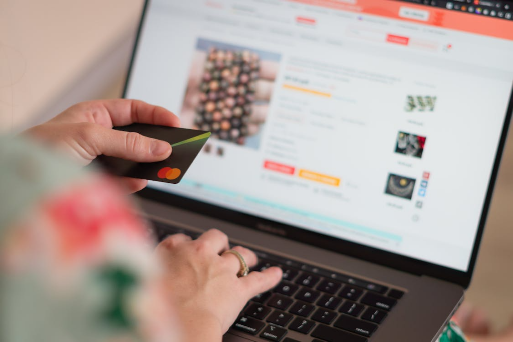 Online shopper using credit card illustrating psychology behind impulse buying.