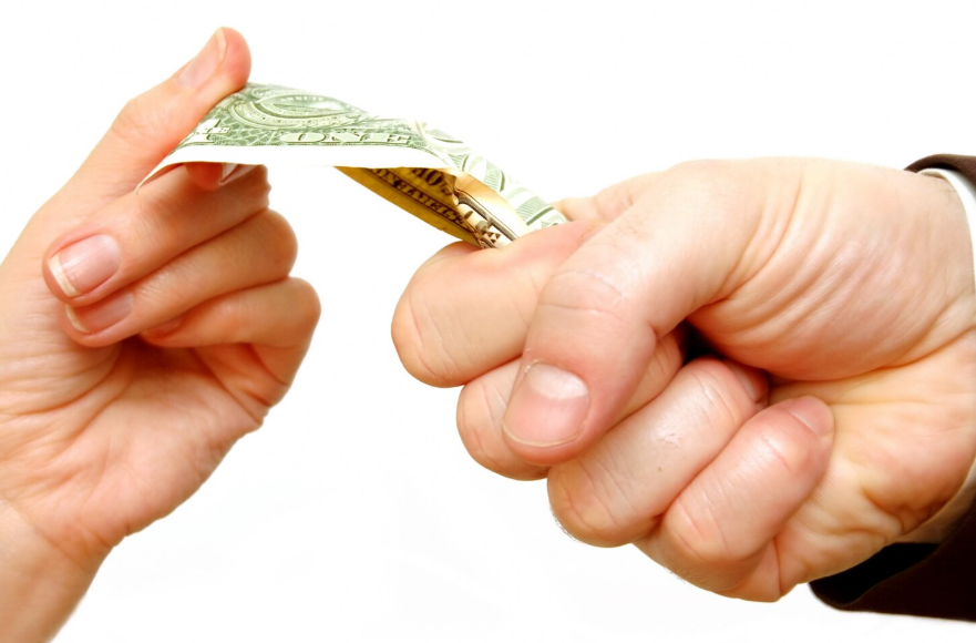 Bent dollar bill symbolizing when frugality backfires and causes financial strain.