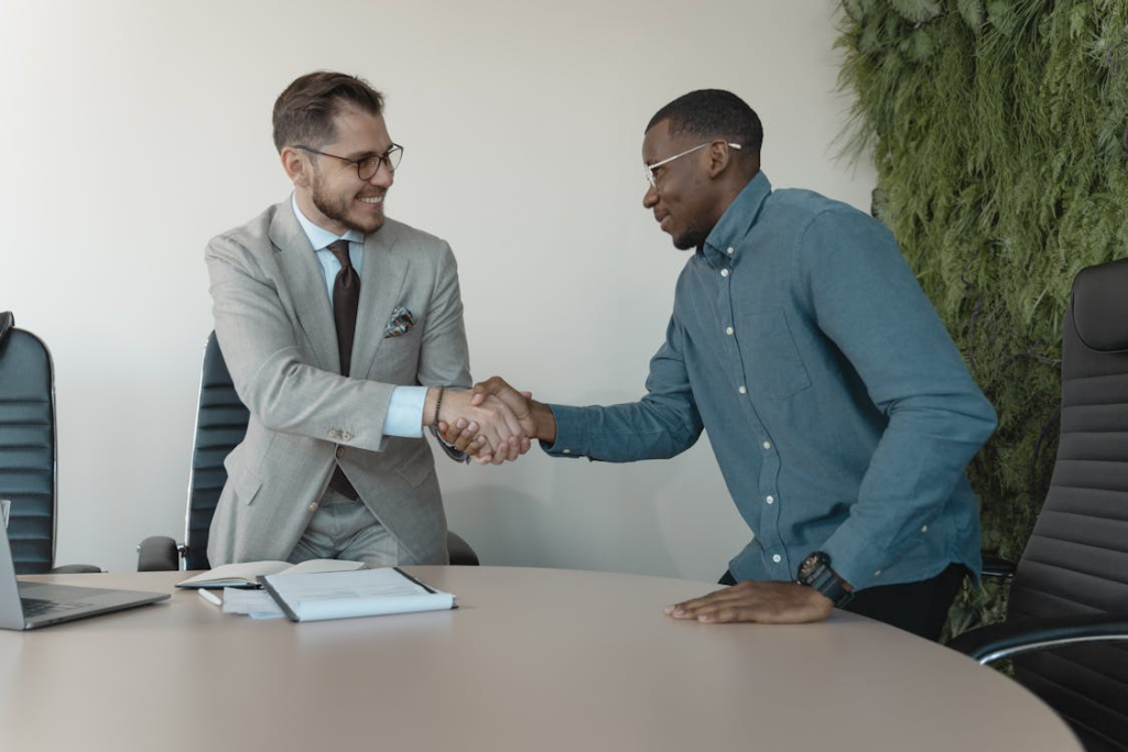 Handshake after a job offer, symbolizing if relocating for work is a good decision.