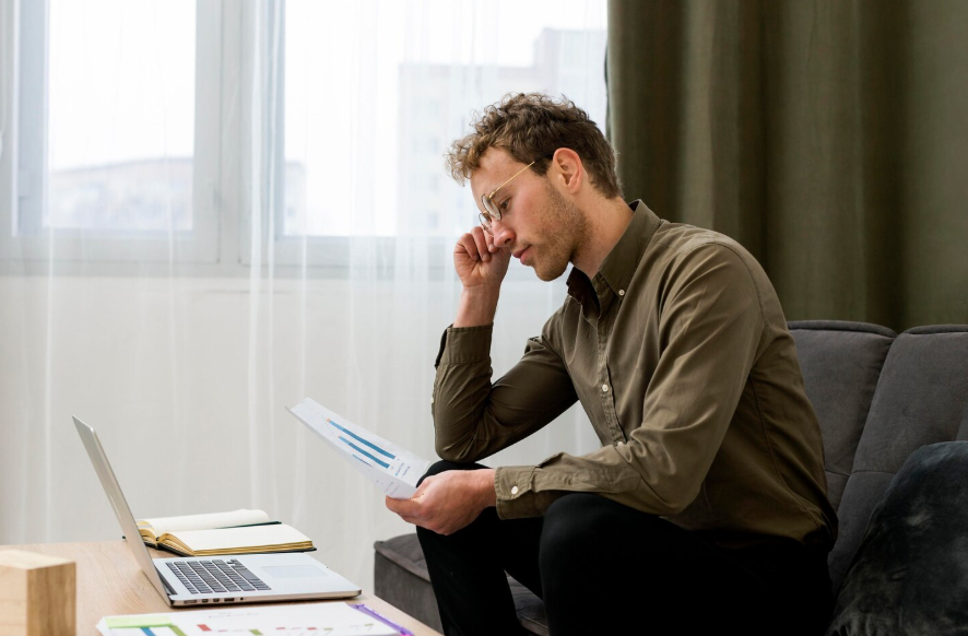 how emotions affect financial decisions shown by man reviewing financial report